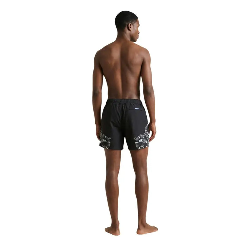 Black swim trunks by County of Milan with bold white floral pattern on lower legs for men swimwear