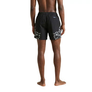 Black County of Milan men swimwear swim trunks featuring bold white and gray snake patterns on the outer sides