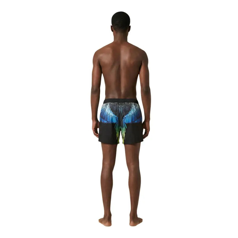 Black swim trunks by County Of Milan with vibrant blue and green wing design on the back for men swimwear