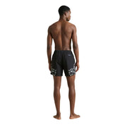 Black swim trunks by County of Milan featuring bold white floral pattern on lower legs suitable for men swimwear
