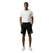 County Of Milan shorts for men in black with neon green pixelated graphic and white logo, front view