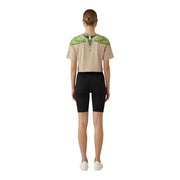 County of Milan women beige cotton round neck t-shirt with vibrant green and white wing graphic across the shoulders