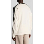 Cream-colored sweatshirt with black and white striped shoulder panels from cream and beige sweatshirts with contrasting details