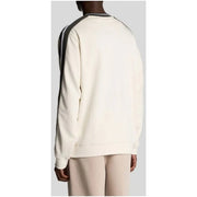 Cream-colored sweatshirt with black and white striped shoulder panels from cream and beige sweatshirts with contrasting details
