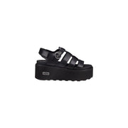 Black leather platform sandal with glossy upper multiple straps silver buckle and thick rubber sole cole logo visible