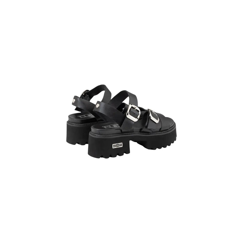 Black leather platform sandals with silver-toned bow buckles and chunky textured sole by Cult Women