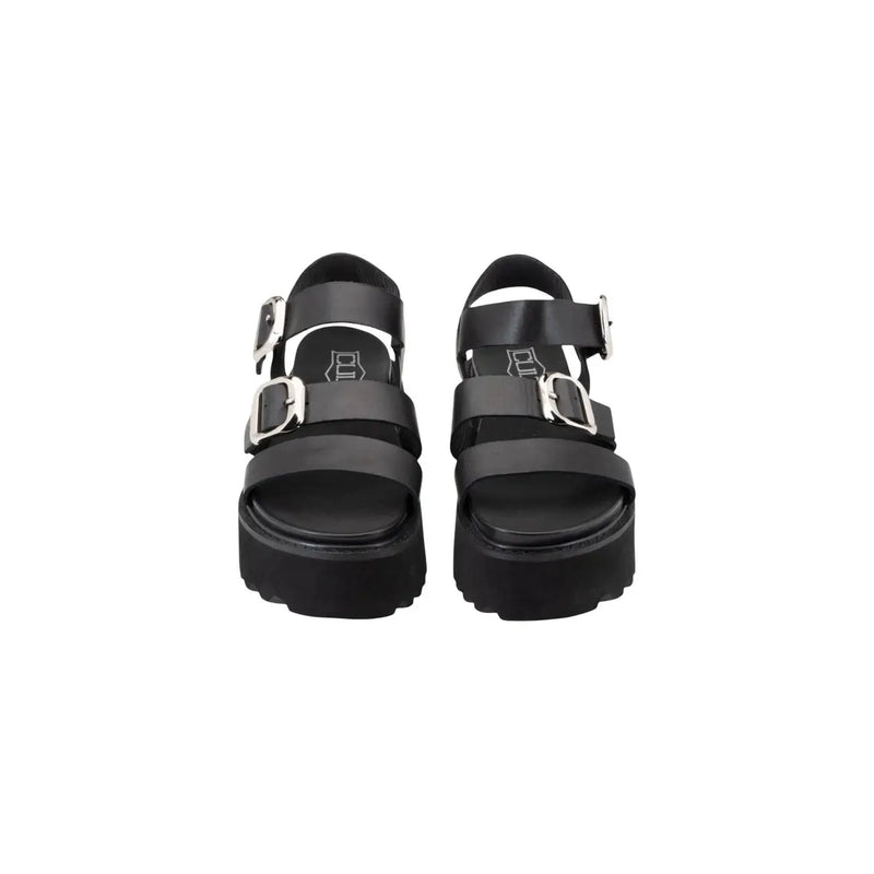 Black leather platform sandals by Cult Women featuring two silver bow buckle straps and a chunky sole