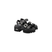 Black leather platform sandals with silver bow buckles and chunky textured sole by Cult Women