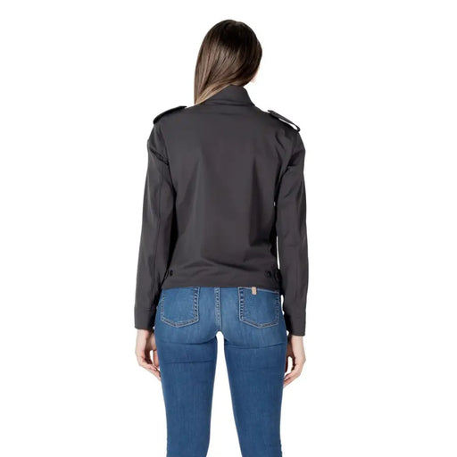Dark gray collared jacket in black trench coat style with shoulder epaulets and sleek modern design