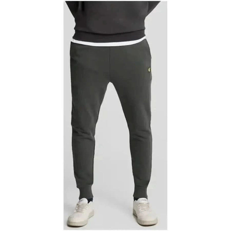 Dark gray Lyle & Scott sweatpants with yellow logo on upper left thigh