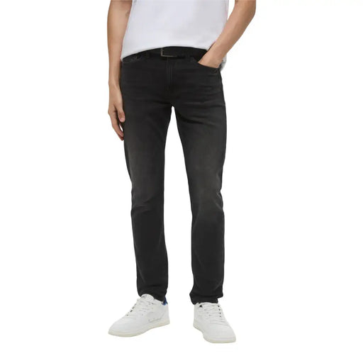 Black slim-fit denim jeans with subtle faded wash and classic five-pocket design from Calvin Klein dark wash jeans