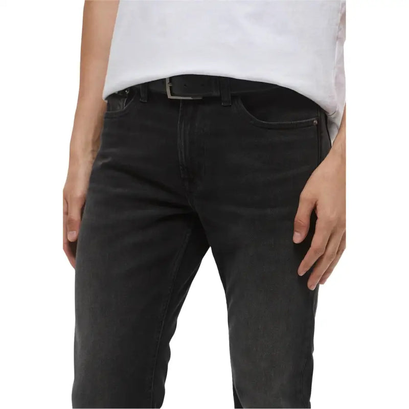 Dark wash jeans by Calvin Klein slim fit black denim with subtle fading and classic five-pocket design