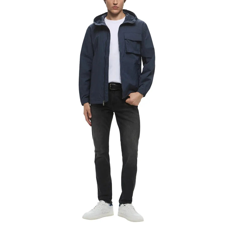Dark navy hooded jacket with sleek modern design and two front pockets paired with dark wash jeans by calvin klein