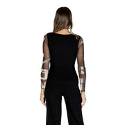 Woman wearing Desigual black long-sleeved blouse with sheer patterned sleeves for women
