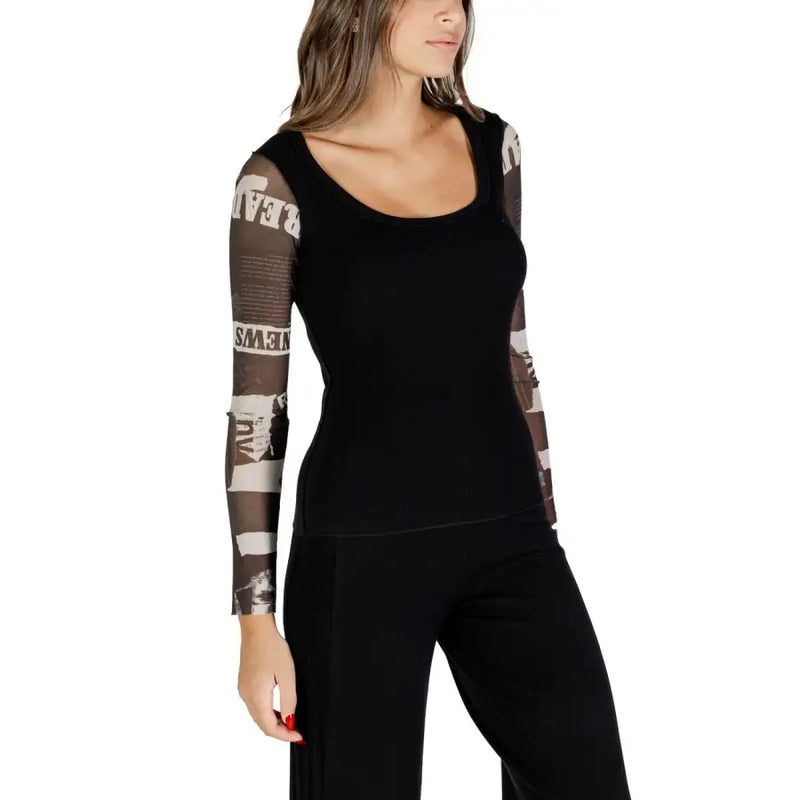 Women’s black long-sleeved blouse with sheer patterned sleeves for fall winter fashion