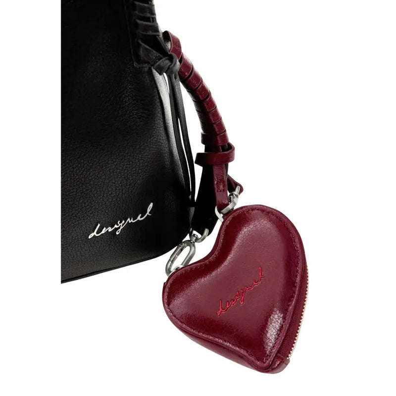 A glossy burgundy leather heart-shaped coin purse with silver zipper and Desigual logo stitched in red thread