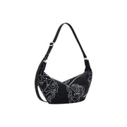 Black crescent-shaped polyurethane shoulder bag with silver stud embellishments and zip closure