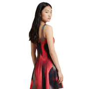Desigual black sleeveless square neck dress with vibrant red and black abstract print and flowing pleated skirt