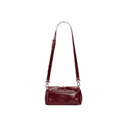 A sleek glossy burgundy leather Desigual bordeaux women crossbody bag with button closure and inside pocket