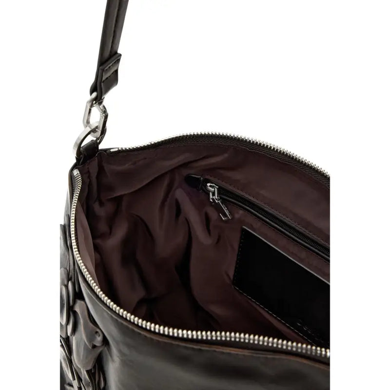 Black leather handbag with floral appliqué detailing and silver-toned zippers shown from the back side