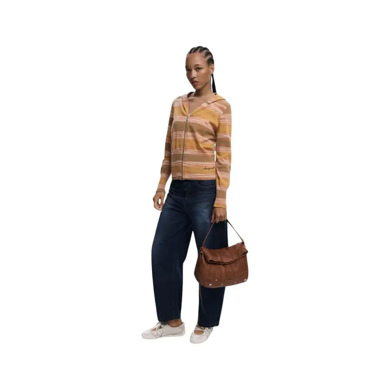 Woman in striped hoodie and jeans holding Desigual brown shoulder handbag with pocket
