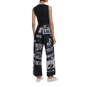 Black sleeveless top and black and white newspaper print wide-leg pants from Desigual Fall Winter Jumpsuit