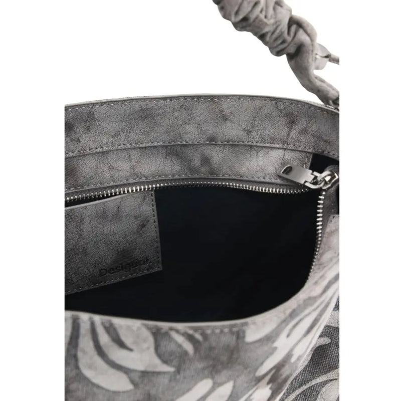 Desigual grey floral cotton handbag with gray distressed leather bucket bag style, braided handle, and tropical leaf print