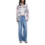 Women’s white printed long sleeve cotton blouse paired with light blue wide-leg jeans and white shoes