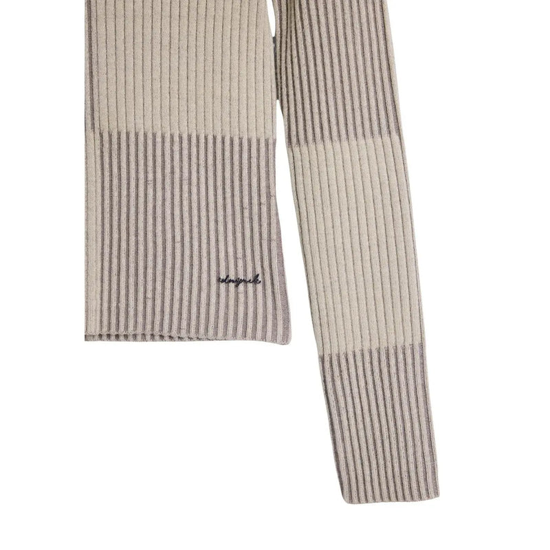 Beige-grau gestreifter Rippstrickschal mit dezent gesticktem Logo, kombiniert mit einem beigefarbenen Rollkragenpullover von Desigual für Damen.