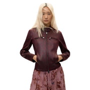 A sleek burgundy leather moto jacket with central zipper and two front pockets for stylish outerwear use