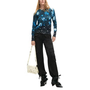 Desigual women black floral knitwear paired with a cream crossbody bag featuring newspaper print and black hardware