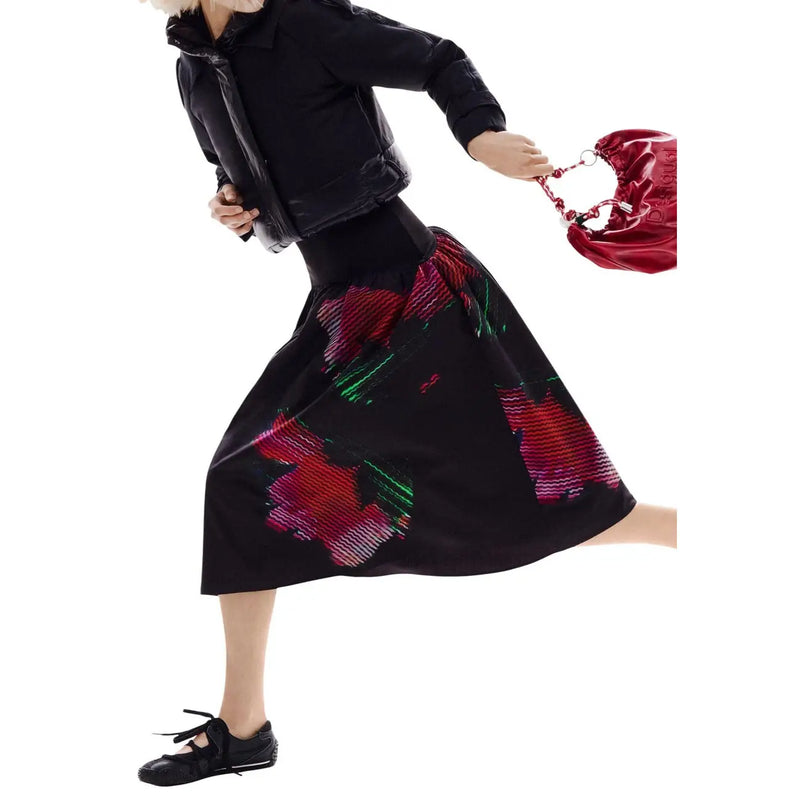 A glossy red patent leather bucket bag with braided chain handle paired with desigual women black floral skirt spring summer