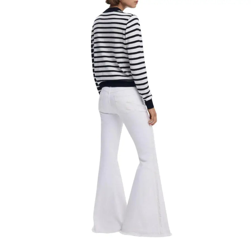 Women wearing Desigual black striped round neck knit sweater with white flare pants
