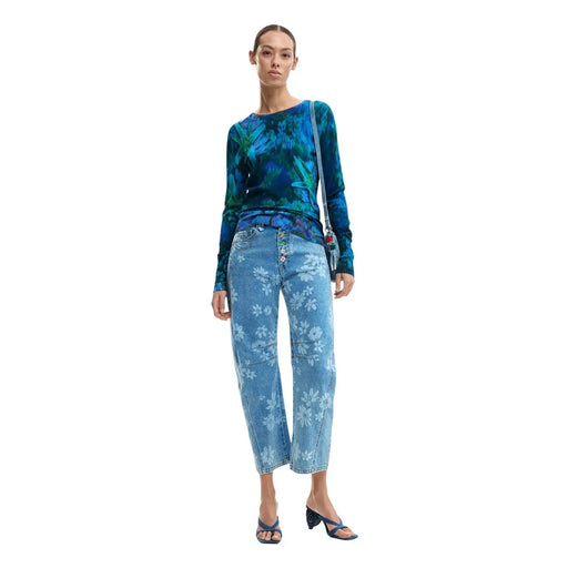 Desigual women blue floral long sleeve round neck knitwear paired with blue floral patterned denim jeans with white flowers