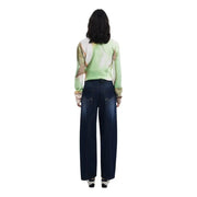 Woman wearing Desigual Blue Worn Out Effect Fall Winter Jeans with patterned top and white sneakers