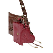 Desigual women brown faux leather bag 17 cm shown as a glossy red heart-shaped wallet with textured surface and gold hardware