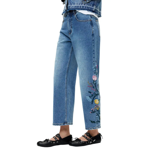 Jean en denim de coton bleu de Desigual avec broderie florale colorée le long de la jambe extérieure pour femme