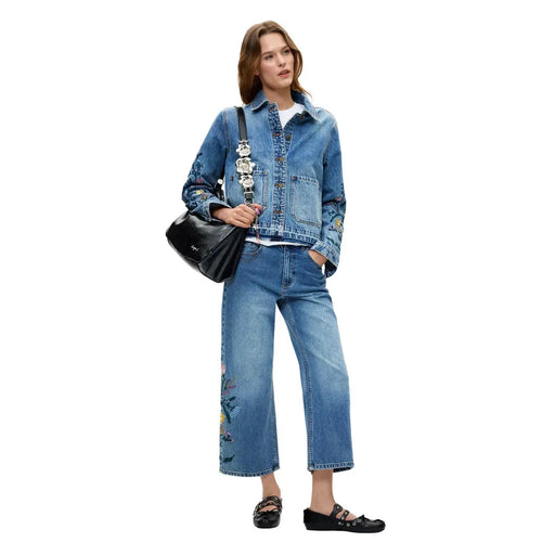 Veste en jean bleu avec broderies florales sur les manches et les jambes, en coton, issue de la collection de jeans femme Desigual.