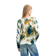 A woman wearing desigual women floral knitwear white viscose blouse with long sleeves and blue green abstract print