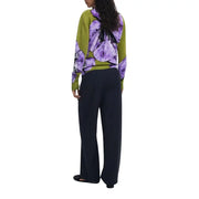 Woman wearing Desigual green floral long sleeve round neck knitwear with dark wide-leg pants