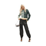 Black cargo pants with elastic cuffs and multiple pockets styled with desigual women green wool blend knitwear pullover
