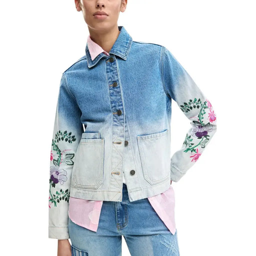 Denim jacket with gradient fade blue to white and vibrant pink purple floral embroidery on sleeves by Desigual women
