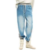 Desigual women light blue denim jogger pants with faded gradient, gray side panels, elastic waistband, and white drawstrings