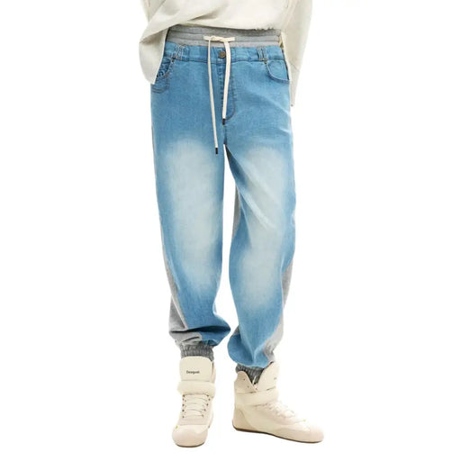 Desigual women light blue denim jogger pants with faded gradient, gray side panels, elastic waistband, and white drawstrings