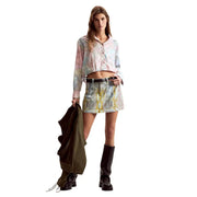 Pastel tie-dye denim mini skirt with subtle pattern and belt loops paired with Desigual women pink long floral cotton shirt classic fit