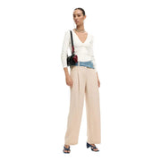 Desigual women trousers beige zip button viscose blend with a black crossbody bag featuring red leather accent and denim strap