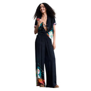 Black tropical-print jumpsuit by Desigual women featuring vibrant floral and bird motifs on lightweight viscose fabric
