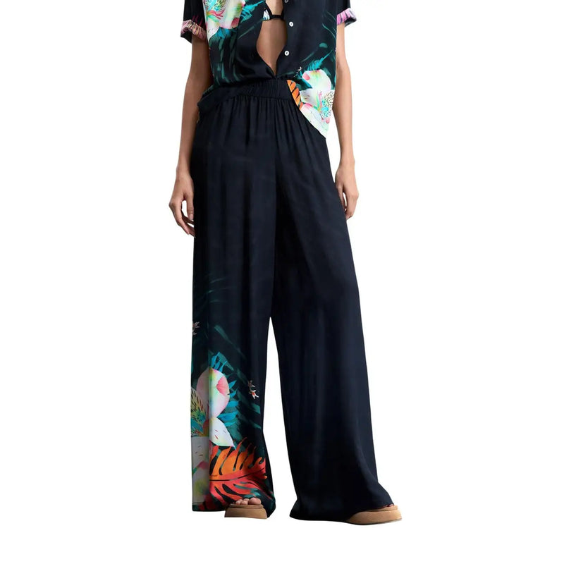 Black wide-leg viscose trousers by Desigual featuring a vibrant tropical floral print down the side
