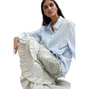 A light gray viscose long skirt with layered ruffles and spiral embroidered detail paired with a light blue round neck shirt by Desigual