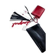Red and black leather keychain with star charms tassels and silver heart pendant attached to desigual women wallet black polyurethane zip